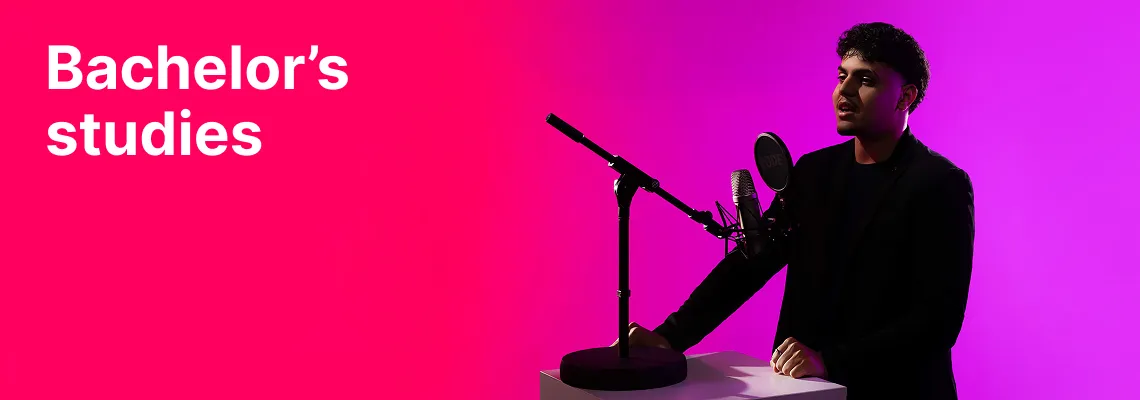 A KTU Faculty of Social Sciences, Humanities and Arts student recording audio in a studio microphone setup against a pink and violet decorative background. The faculty offers bachelor's studies. Choose KTU bachelor's studies.