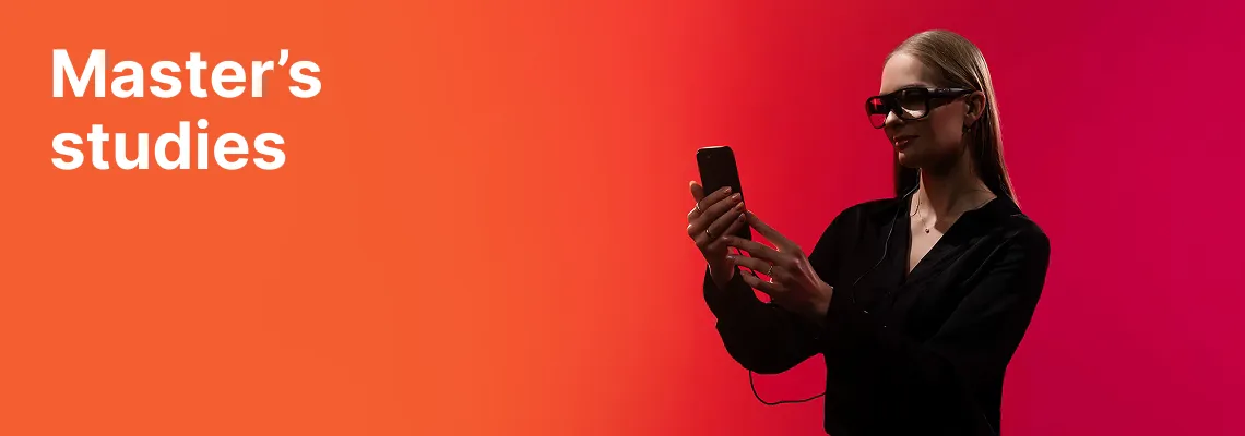 A KTU Faculty of Social Sciences, Humanities and Arts student working with a smartphone and wearing smart glasses against an orange and red decorative background. The faculty offers master's studies. Choose KTU master's studies.