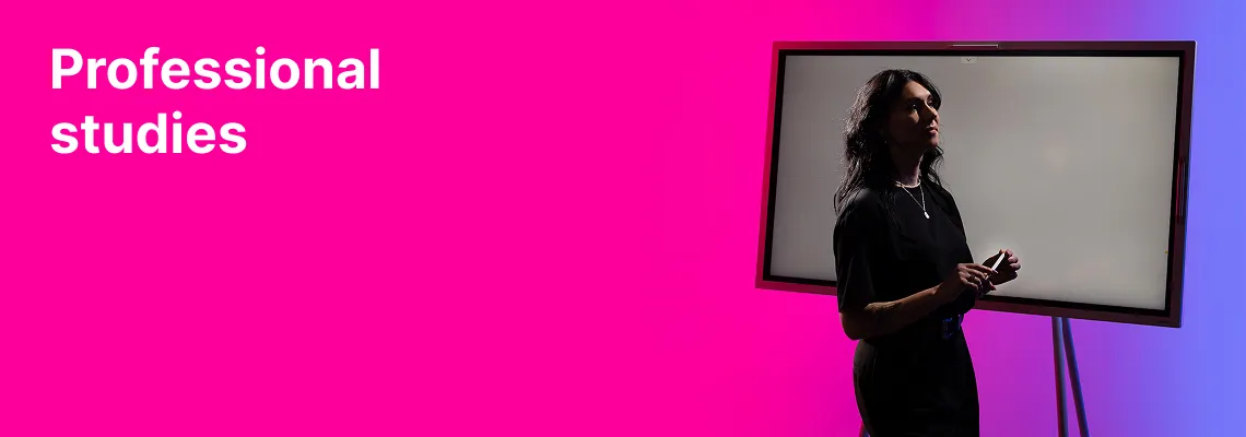 A KTU Faculty of Social Sciences, Humanities and Arts student presenting information on a touchscreen against a pink decorative background. KTU Pedagogical Professional Studies — enrich your knowledge and yourself.
